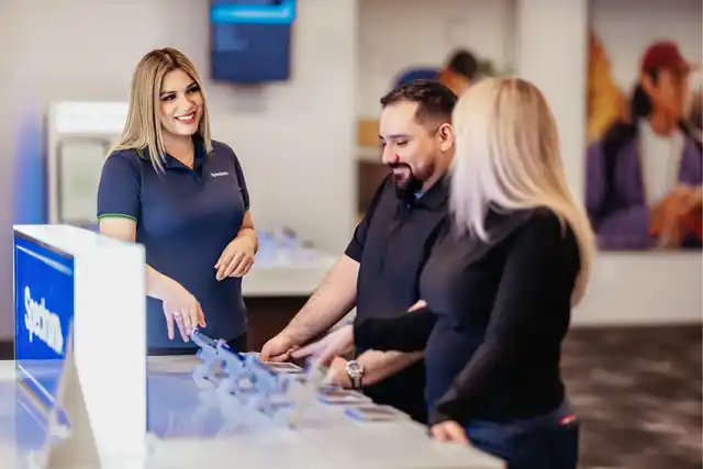 Smiling Spectrum store associate welcoming customers